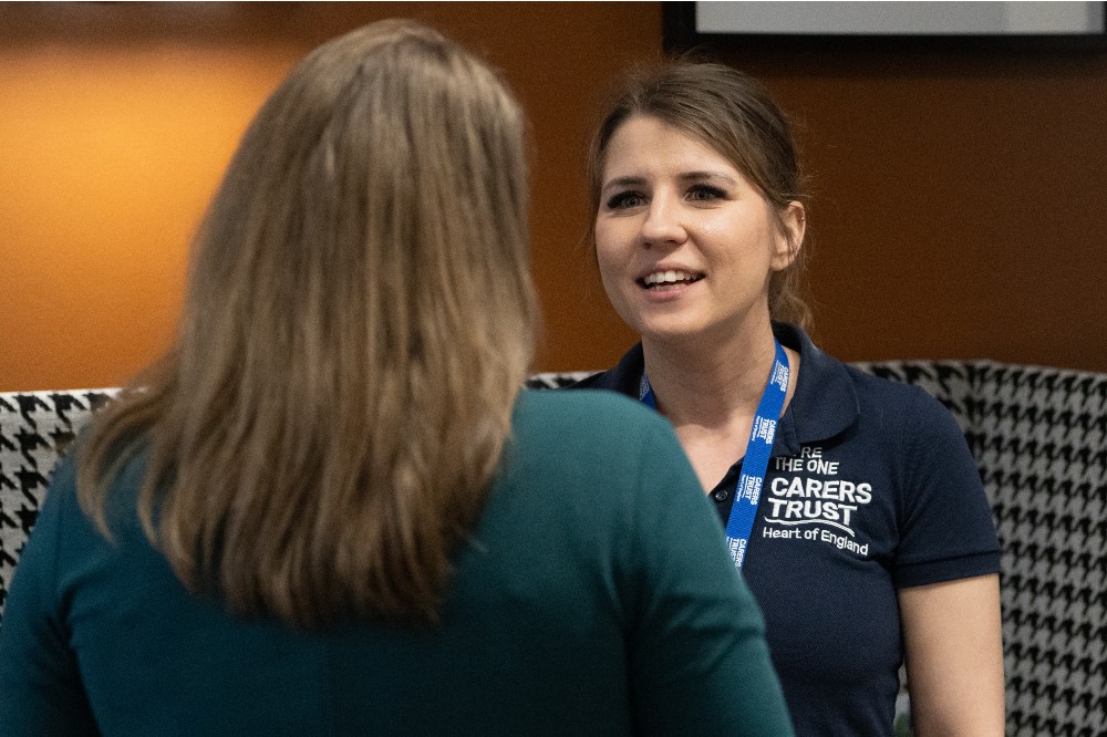A person from Carers Trust talking to another person