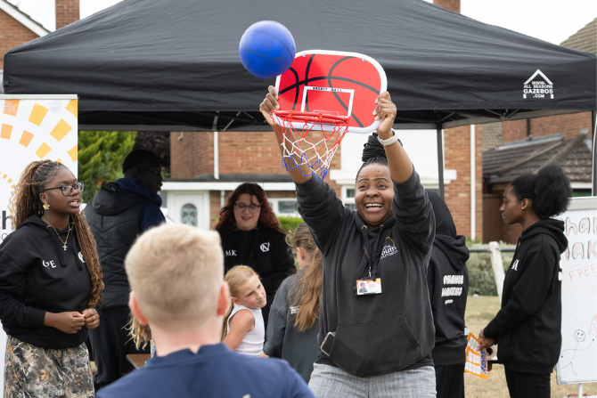 A person holding a basketball net.