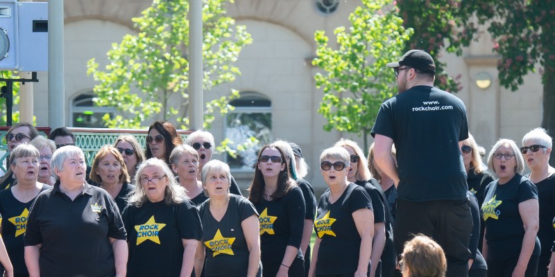 Choir mid song outdoors.