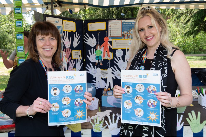 Two women stood in front of their stall for Rise charity.